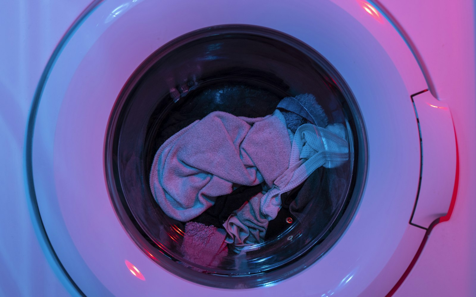 Clothes tumbling inside a washing machine drum